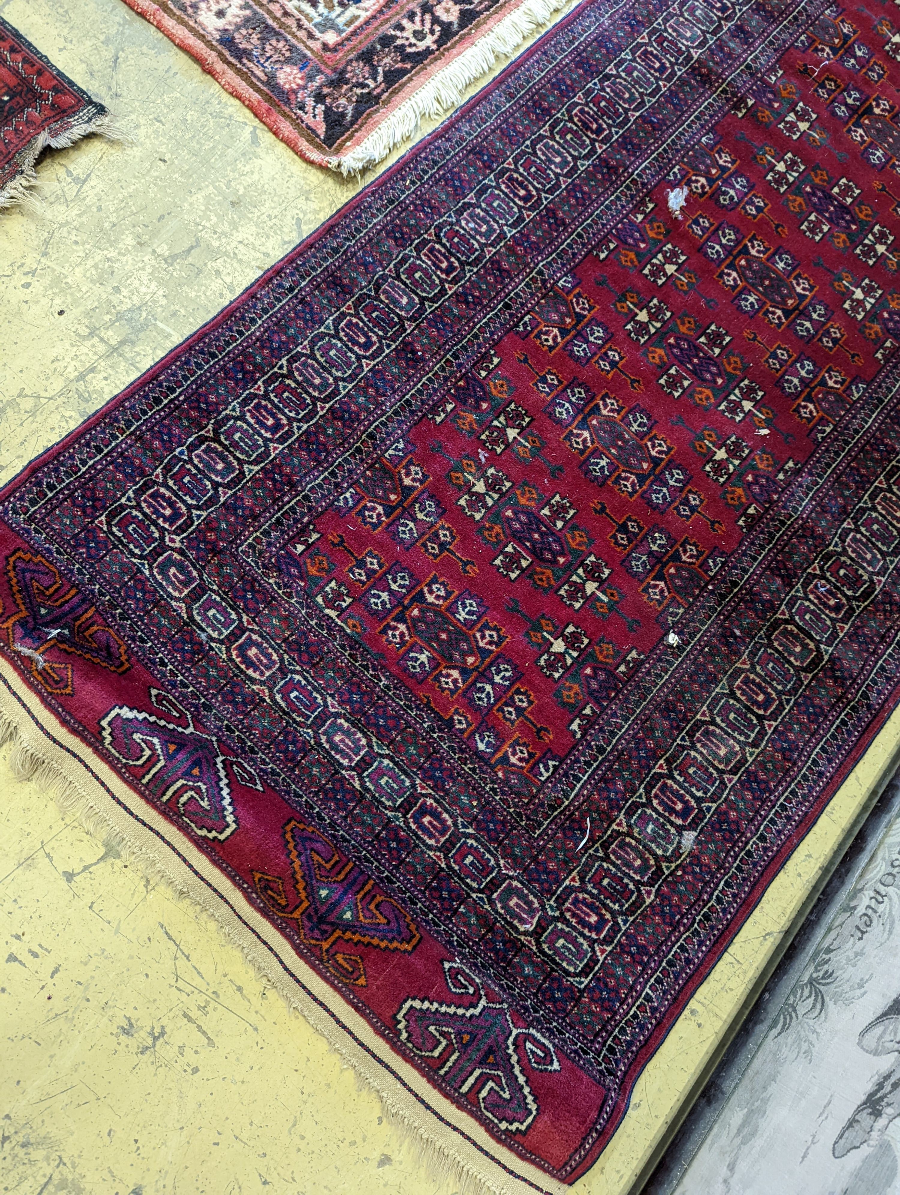 A Bokhara burgundy ground runner, 276 x 88cm